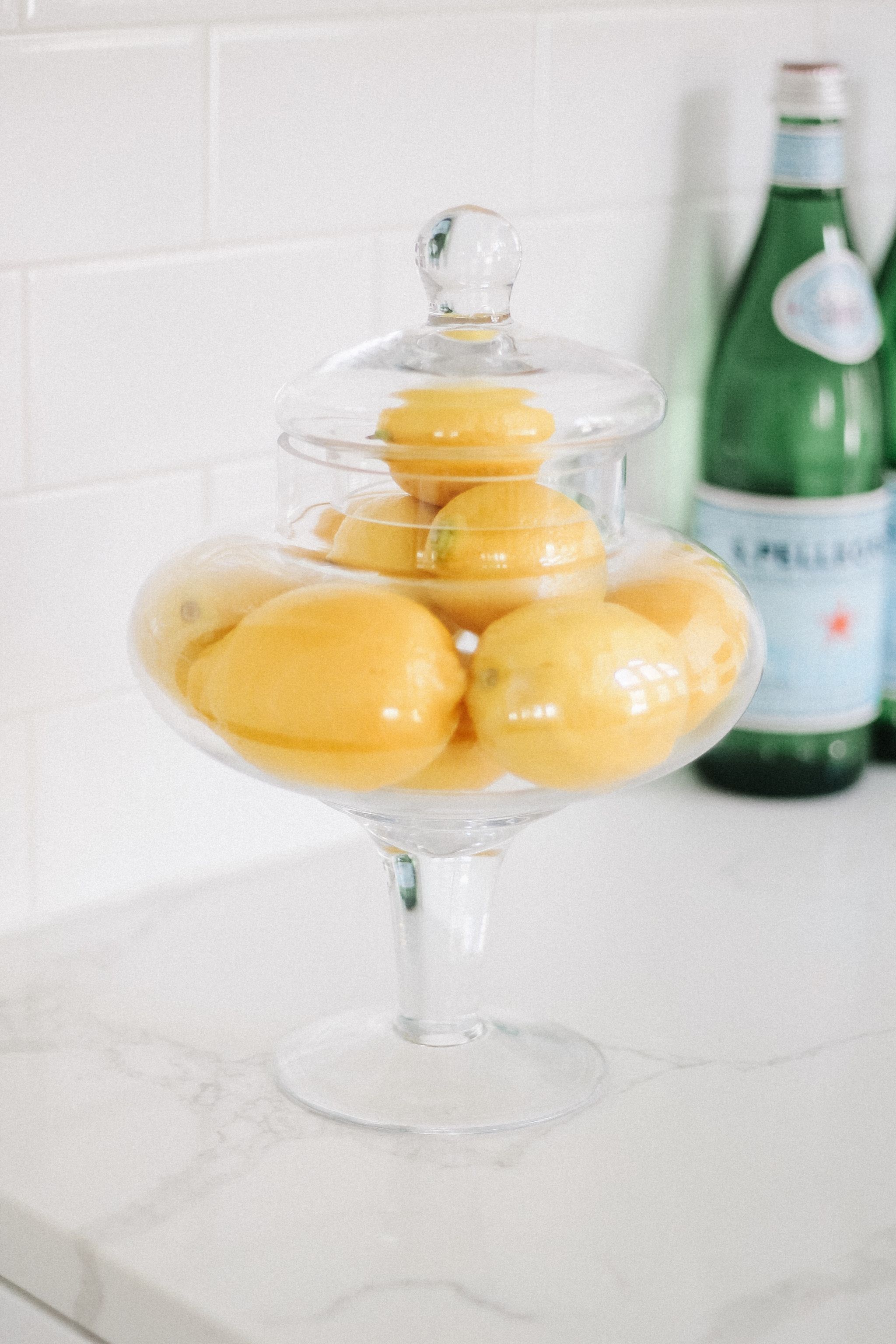 lemons in vase kitchen counter 